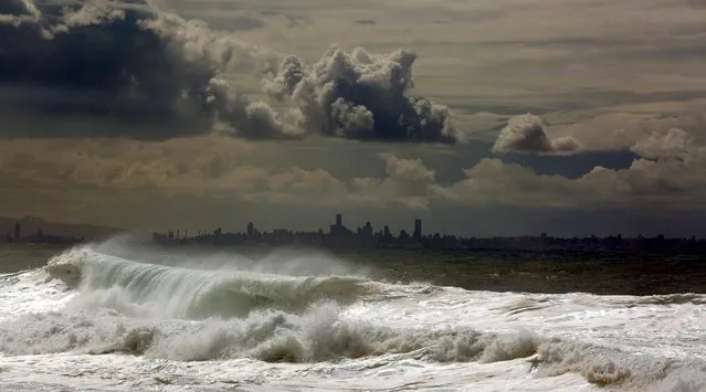 Sea waves hit the world oldest port of Byblos as the Lebanese capital Beirut appears in the background on February 22, 2016. (Photo by Patrick Baz/AFP Photo)