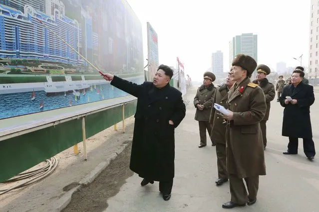 North Korean leader Kim Jong Un (L) issues instructions while visiting the construction site of the Mirae Scientists Street in Pyongyang in this undated photo released by North Korea's Korean Central News Agency (KCNA) in Pyongyang February 15, 2015. (Photo by Reuters/KCNA)