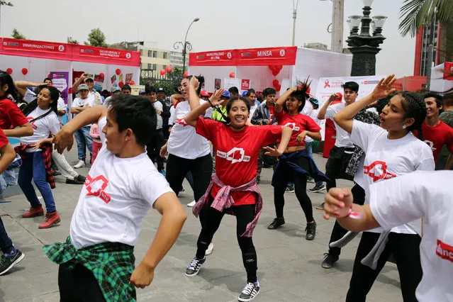 People dance during HIV prevention campaign marking the World AIDS Day in Lima, Peru December 1, 2016. (Photo by Mariana Bazo/Reuters)