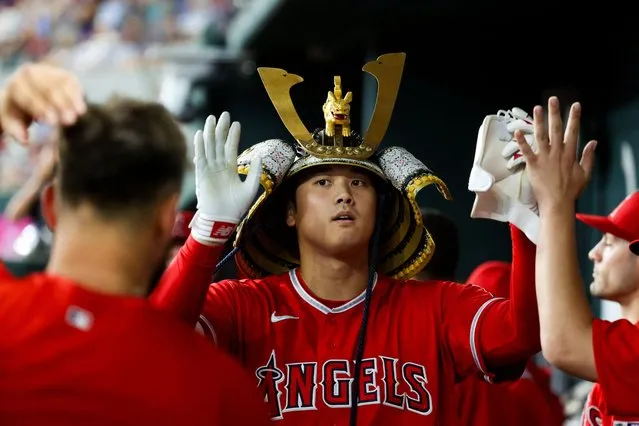Los Angeles Angels designated hitter Shohei Ohtani (17) celebrates with teammates while wearing a samurai helmet after hitting a home run during the first inning against the Texas Rangers at Globe Life Field in Arlington, Texas on August 16, 2023. (Photo by Kevin Jairaj/USA TODAY Sports)