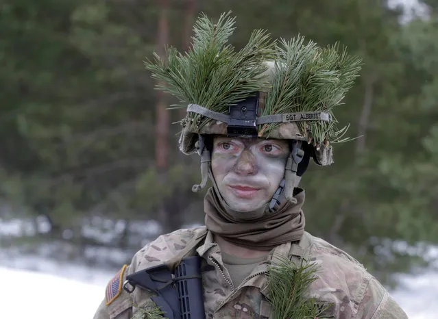 U.S. soldier Douglas Alberts along with the other troops from 11 NATO nations takes part in the exercise in urban warfare during Iron Sword exercise in the mock town near Pabrade, Lithuania, December 2, 2016. (Photo by Ints Kalnins/Reuters)