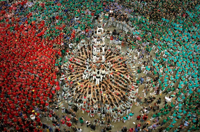 Members of group “Castellers de Sants” form a human tower called “castell” during a biannual human tower competition in Tarragona, Spain, October 7, 2018. (Photo by Albert Gea/Reuters)