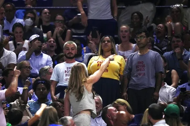 An audience member yells at protesters as they demonstrate at a match between Coco Gauff, of the United States, and Karolina Muchova, of the Czech Republic, during the women's singles semifinals of the U.S. Open tennis championships, Thursday, September 7, 2023, in New York. (Photo by Frank Franklin II/AP Photo)