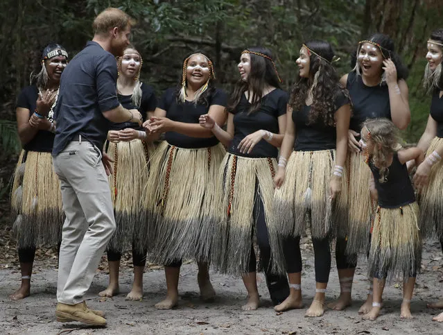 Britain's Prince Harry meets local dancers after the unveiling of the Queens Commonwealth Canopy at Pile Valley, K'gari during a visit to Fraser Island, Australia, Monday, October 22, 2018. Prince Harry and his wife Meghan are on day seven of their 16-day tour of Australia and the South Pacific. (Photo by Kirsty Wigglesworth/AP Photo)