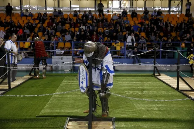 A man dressed as a knight rests during a fight at an international medieval tournament in Tel Aviv, January 23, 2016. (Photo by Baz Ratner/Reuters)