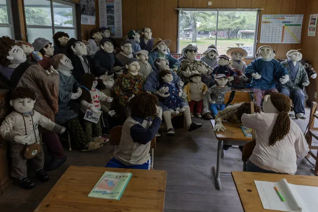 Handmade human-sized scarecrows are displayed in the abandoned building used as a school classroom in the village of “Kakasi No Sato” on September 20, 2023 in Yasutomi, Japan. (Photo by Buddhika Weerasinghe/Getty Images)