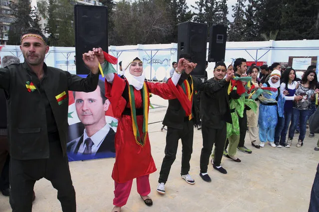 Syrian Kurds dance to celebrate Nowruz, the Kurdish new year, in Damascus, Syria, Saturday, March 21, 2015. (Photo by AP Photo)