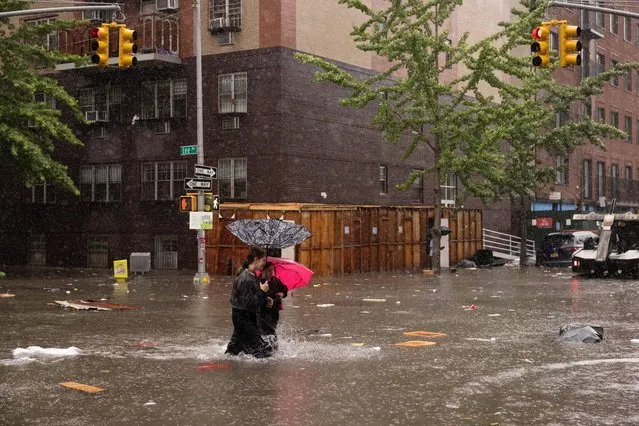 People walk on a flooded street during a heavy rain storm in the Brooklyn borough of New York City on Friday, September 29, 2023. (Photo by Yuki Iwamura for The Washington Post)