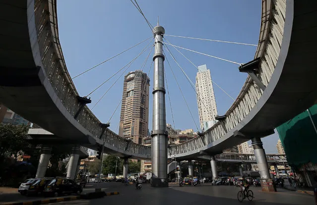 Commuters travel beneath the Nana Chowk skywalk in Mumbai, India, November 16, 2018. (Photo by Francis Mascarenhas/Reuters)