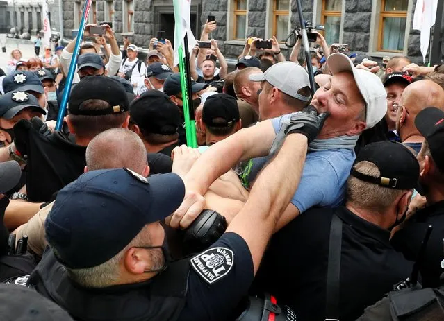 Ukrainian law enforcement officers block demonstrators during a rally of entrepreneurs and representatives of small businesses to demand governmental support in front of the Presidential Office building in Kyiv, June 29, 2021. (Photo by Gleb Garanich/Reuters)