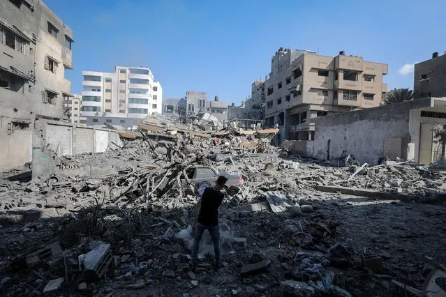 A Palestinian inspects the rubble of a destroyed building following an Israeli air strike in Gaza City, 19 October 2023. More than 3,700 Palestinians and 1,400 Israelis have been killed according to the Israel Defense Forces (IDF) and the Palestinian Health authority since Hamas militants launched an attack against Israel from the Gaza Strip on 07 October. Israel has warned all citizens of the Gaza Strip to move to the south ahead of an expected invasion. (Photo by Mohammed Saber/EPA)