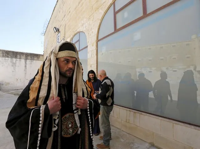A prison inmate in biblical costume waits to take part in a Passion play in the run-up to Easter at the Corradino Correctional Facility, Malta's main prison, in Paola, outside Valletta, March 23, 2015. Eighteen prison inmates are taking part in the play “His Love Changed Me” which is based on the story of Mary Magdalene, the woman who was saved by Jesus Christ from being stoned by a mob. (Photo by Darrin Zammit Lupi/Reuters)