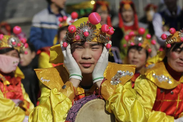 Performers wait for their turn to go onto the stage at the Longtan park as the Chinese Lunar New Year, which welcomes the Year of the Monkey, is celebrated in Beijing, China February 9, 2016. (Photo by Damir Sagolj/Reuters)