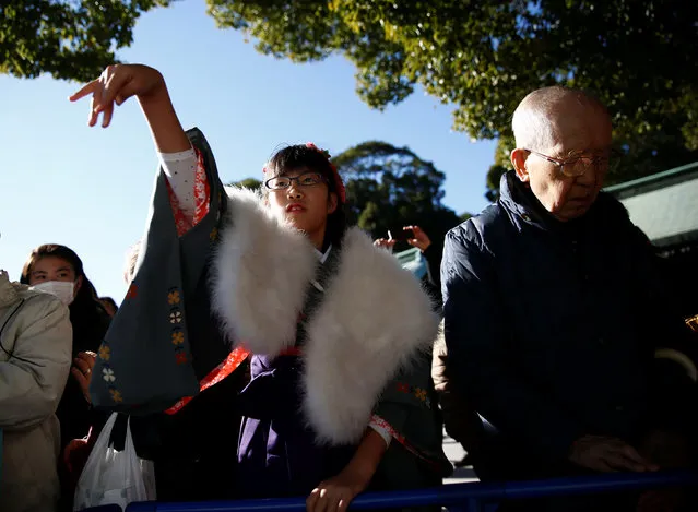 A girl in kimono throws a coin into a giant offering box on the first day of the new year at Meiji Shrine in Tokyo, Japan, January 1, 2017. (Photo by Kim Kyung-Hoon/Reuters)