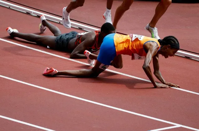 Sifan Hassan of the Netherlands and Edina Jebitok of Kenya fall down during heat 2 of the women's 1500m round at Olympic Stadium in Tokyo, Japan on August 2, 2021. (Photo by Phil Noble/Reuters)