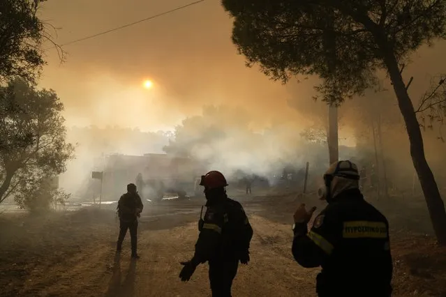 Firefighters operate during a wildfire in Siderina village about 55 kilometers (34 miles) south of Athens, Greece, Monday, August 16, 2021. Two new big wildfires fanned by strong winds erupted Monday in hard-hit Greece, triggering evacuation alerts for villages southeast and northwest of Athens – days after blazes consumed large tracts of forest to the capital's north. (Photo by Thanassis Stavrakis/AP Photo)