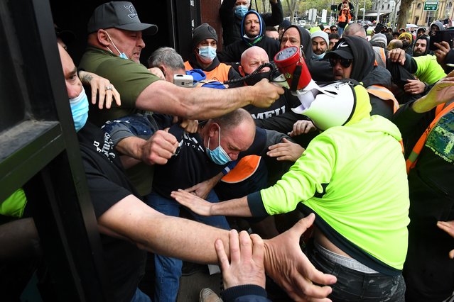 Construction workers clash with unionists at a protest at Construction, Forestry, Maritime, Mining and Energy Union (CFMEU) headquarters in Melbourne, Monday, September 20, 2021. Construction workers are protesting mandatory Covid19 vaccinations. (Photo by James Ross/AAP Image)