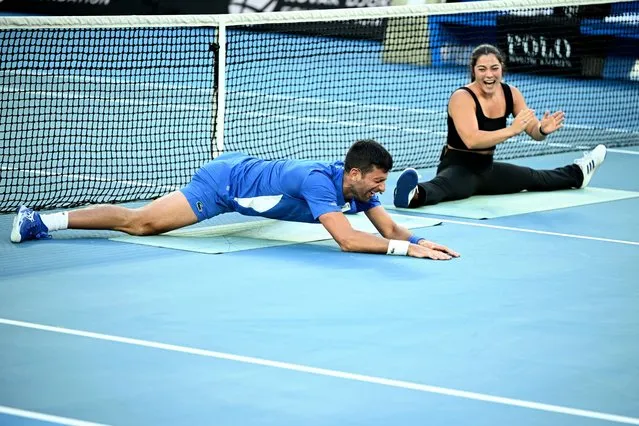 Novak Djokovic of Serbia (left) stretches with Australian gymnast Georgia Godwin during “A Night with Novak and Friends” charity tennis matches at Rod Laver Arena in Melbourne, Australia, 11 January 2024. (Photo by Joel Carrett/EPA/EFE)