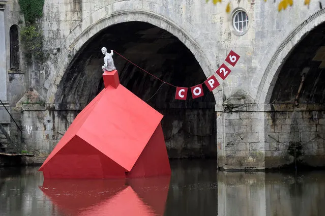 An installation of a “Sinking House” is partly submerged to highlight climate change ahead of COP26, in Bath, Britain on October 26, 2021. (Photo by Rebecca Naden/Reuters)