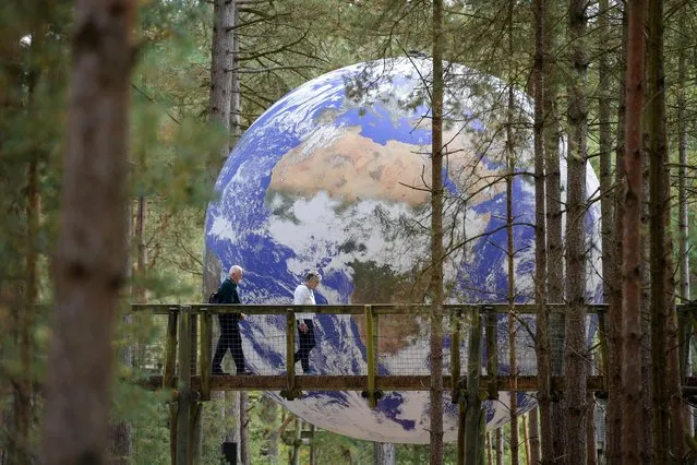 Luke Jerram's installation “Gaia” is displayed at Moors Valley Country Park and Forest, on September 17, 2021 in Ashley Heath, England. British artist Luke Jerram's installation “Gaia”, a 7 meter replica of planet Earth, is suspended in the park as part of Inside Out Dorset's international arts festival. Running from 17-26 September 2021, Activate’s Inside Out Dorset is an international outdoor arts festival commissioning and presenting a range of UK and European artists. (Photo by Finnbarr Webster/Getty Images)