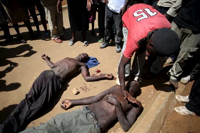 Two men lie unconscious on the ground by a road side as witnesses say that one of the men (L)  physically attacked the other and himself was in return assaulted by an angry crowd, Eldoret, western Kenya, March 21, 2016. (Photo by Siegfried Modola/Reuters)