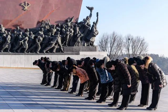People bow as they visit the statues of late North Korean leaders Kim Il-Sung and Kim Jong-Il to pay their respects on the occasion of the 82nd birthday of late North Korean leader Kim Jong Il, known as the “Day of the Shining Star”, on Mansu Hill in Pyongyang on February 16, 2024. (Photo by Kim Won Jin/AFP Photo)