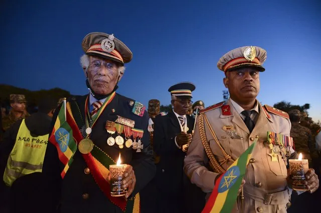 Current and former Ethiopian military personnel and the public commemorate federal soldiers killed by forces loyal to the Tigray People's Liberation Front (TPLF) at the start of the conflict one year ago, at a candlelit event outside the city administration in Addis Ababa, Ethiopia Wednesday, November 3, 2021. All sides in Ethiopia's yearlong war in the Tigray region have committed abuses marked by “extreme brutality” that could amount to war crimes and crimes against humanity, the U.N. human rights chief said Wednesday. (Photo by AP Photo/Stringer)