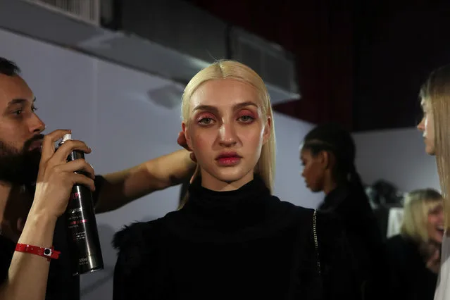 A model gets prepared backstage before Ratier's show during Sao Paulo Fashion Week in Sao Paulo, Brazil April 26, 2019. (Photo by Amanda Perobelli/Reuters)