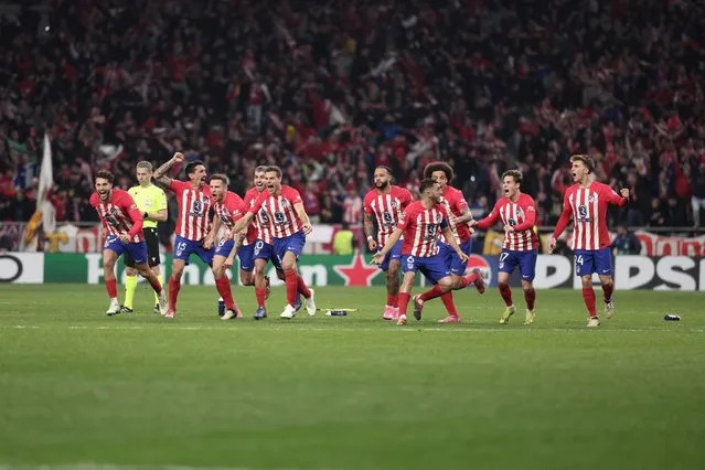 Atletico Madrid's players celebrate victory at the end of the UEFA Champions League last 16 second leg football match between Club Atletico de Madrid and Inter Milan at the Metropolitano stadium in Madrid on March 13, 2024. (Photo by Thomas Coex/AFP Photo)