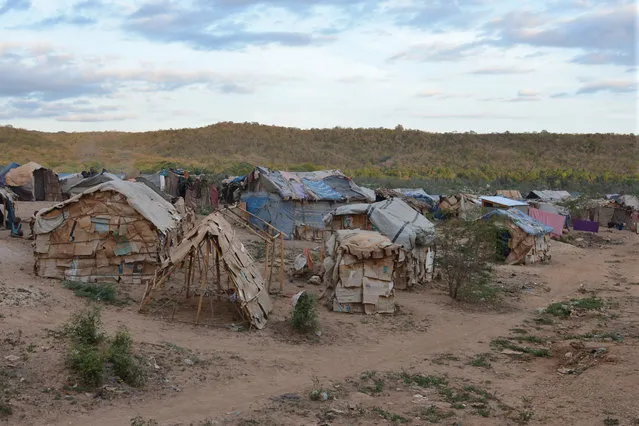 In this March 21, 2015 photo, makeshift tents of flattened cardboard boxes, bedsheets and sticks stand at a borderland encampment outside the southeast Haitian town of Anse-a-Pitres. The encampment is filled with people who either fled or were forcibly removed from the neighboring Dominican Republic amid an immigration crackdown. Within the next month, authorities hope to move nearly 2,400 people out of six encampments by providing subsidies for them to rent homes for a year in southeastern Haiti. The International Organization for Migration is coordinating the effort with $2 million from a U.N. emergency fund. (Photo by David McFadden/AP Photo)