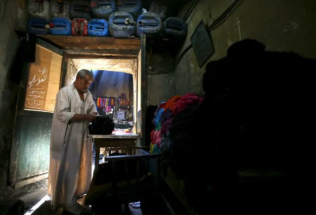 Salama Mahmoud Salama, 75, the owner of a dye workshop looks at yarns at the workshop in old Cairo, Egypt, March 17, 2016. (Photo by Amr Abdallah Dalsh/Reuters)