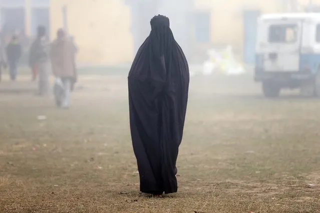 A woman wearing a burka leaves a polling booth after voting during the state assembly election, in the town of Deoband, in the state of Uttar Pradesh, India, February 15, 2017. (Photo by Cathal McNaughton/Reuters)
