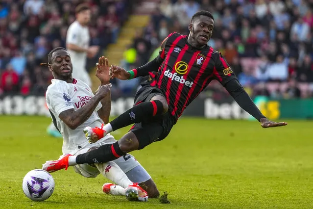 Manchester United's Aaron Wan-Bissaka, left, duels for the ball with Bournemouth's Dango Ouattara during the English Premier League soccer match between Bournemouth and Manchester United, at The Vitality Stadium in Bournemouth, England, Saturday, April 13, 2024. (Photo by Kirsty Wigglesworth/AP Photo)