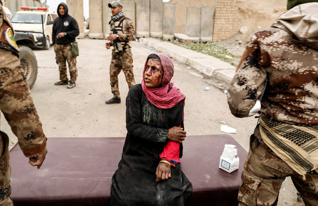 A woman injured in a mortar attack is treated by medics in a field clinic as Iraqi forces battle with Islamic State militants, in western Mosul, Iraq March 2, 2017. (Photo by Zohra Bensemra/Reuters)