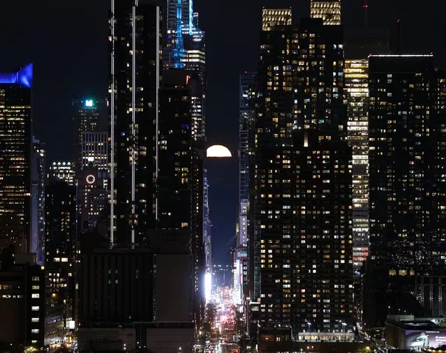 The full Pink Moon rises above 42nd Street in New York City on April 24, 2024, as seen from Weehawken, New Jersey. (Photo by Lokman Vural Elibol/Anadolu via Getty Images)