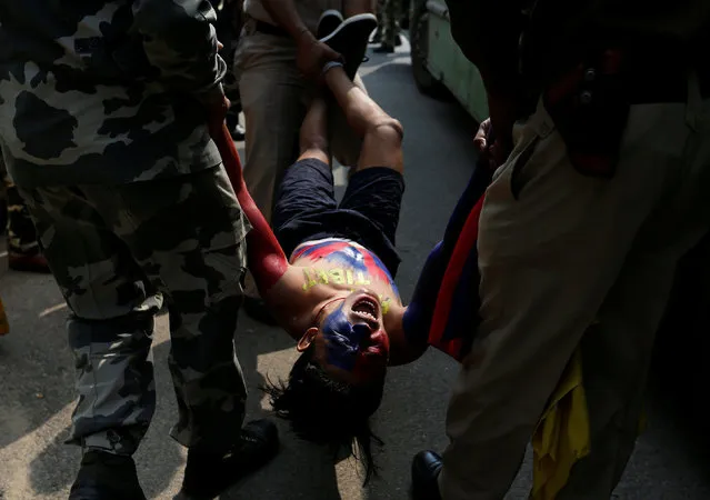 A Tibetan reacts as he is detained by police during a protest held to mark the 58th anniversary of the Tibetan uprising against Chinese rule, outside the Chinese embassy in New Delhi, India, March 10, 2017. (Photo by Cathal McNaughton/Reuters)