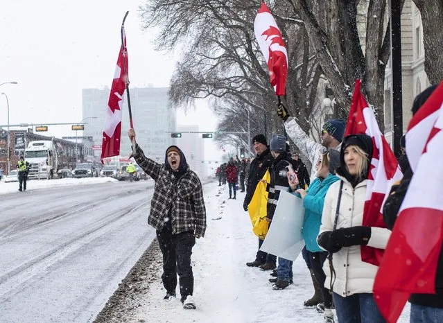 People gather in protest against COVID-19 mandates and in support of a protest against COVID-19 restrictions taking place in Ottawa, in Edmonton, Alberta, Saturday, February 5, 2022. (Photo by Jason Franson/The Canadian Press via AP Photo)