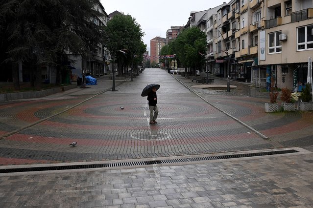 A man walks along the main pedestrian street in the northern municipality of Mitrovica, on April 21, 2024. Four towns in the Serb-majority region of North Kosovo are holding an extraordinary local election on April 21 on whether to oust their ethnic Albanian mayors in a territory riddled with deadly tensions. (Photo by AFP Photo/Stringer)