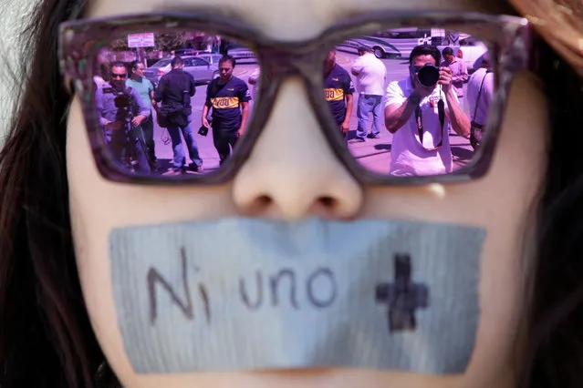 Journalists are reflected on sunglasses of a woman during a protest against the murder of the Mexican journalist Miroslava Breach, outside the Attorney General's Office (PGR) in Ciudad Juarez, Mexico March 25, 2017. Tape reads “No one more”. (Photo by Jose Luis Gonzalez/Reuters)