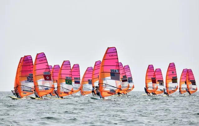 Athletes take part in the women's windsurfing RS:X class competition during a sailing test event for the Tokyo 2020 Olympic Games, off the coast Enoshima in Kanagawa Prefecture, on August 20, 2019. (Photo by Kazuhiro Nogi/AFP Photo)