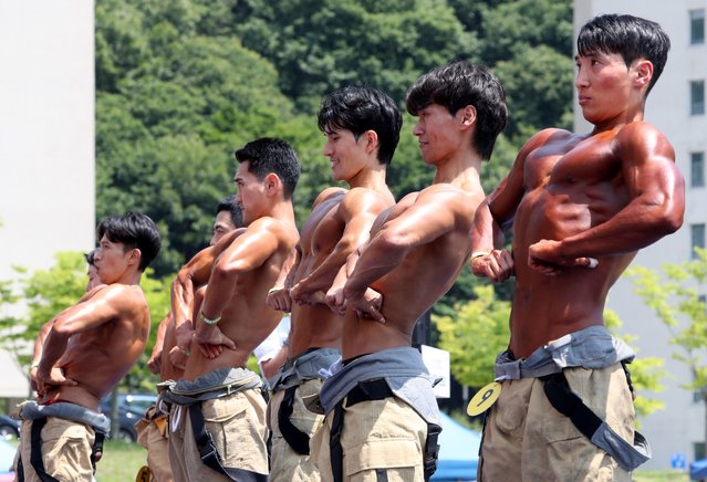 Firefighters take part in the bodybuilding event during a firefighting skills contest at the National Fire Service Academy in Gongju, South Korea on June 3, 2024. (Photo by Shin Hyeon-jong)