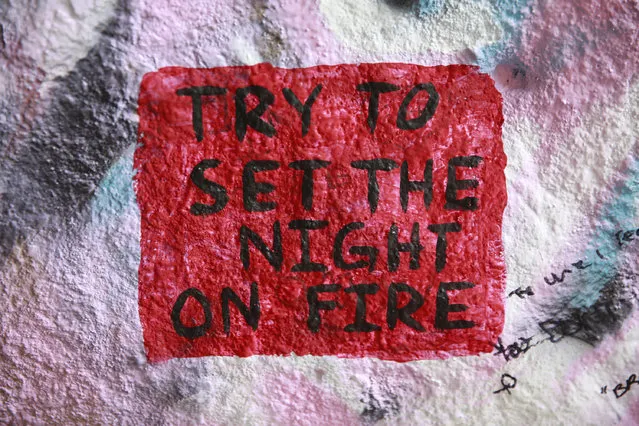 The graffiti reads “Try to set the night on fire”, a lyric from The Doors rock band inside the Corral Canyon Cave in Malibu, Calif., Friday, May, 6, 2016. (Photo by Damian Dovarganes/AP Photo)