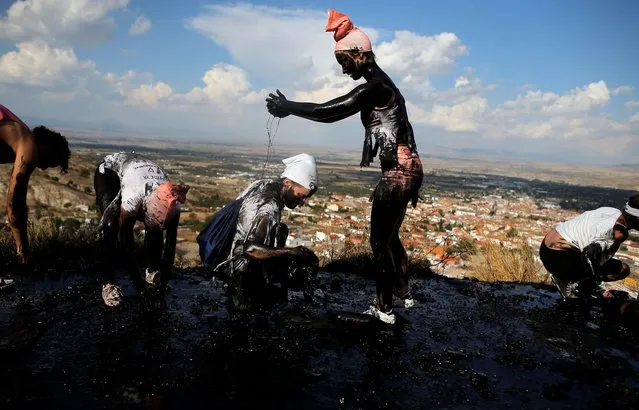 Revellers put grease on their bodies as they take part in the annual Cascamorras festival in Baza, southern Spain on September 6, 2019. (Photo by Jon Nazca/Reuters)