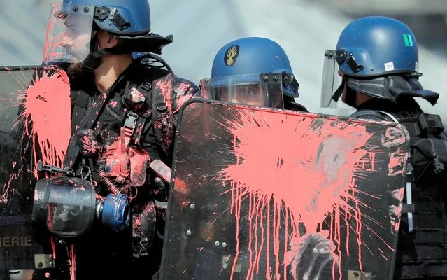French gendarmes are covered with paint as protestors clash with police forces during a demonstration on Act 44 (the 44th consecutive national protest on Saturday) of the yellow vests movement in Nantes, France, September 14, 2019. (Photo by Stephane Mahe/Reuters)
