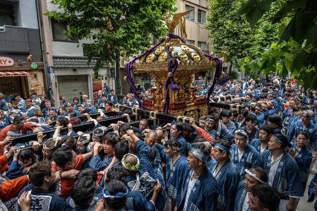 Participants carry a portable shrine or “mikoshi” through the streets during the Tsukiji Shishi Matsuri festival in Tokyo on June 9, 2024. (Photo by Yuichi Yamazaki/AFP Photo)