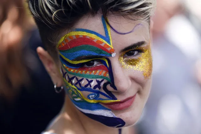 A particpant with her face painted looks on during the lesbian, gay, bisexual and transgender (LGBT) Pride Parade in Pristina, on July 1, 2021. Hundreds of Kosovo people walk along the main street during a pride march demanding “freedom” and “equal rights” in the patriarchal and Muslim majority country with little tolerant views on sexuality. This weekend's Pride marches in cities around the world come in the wake of a row in Europe over different countries approach to the LGBTQ rights. (Photo by Armend Nimani/AFP Photo)