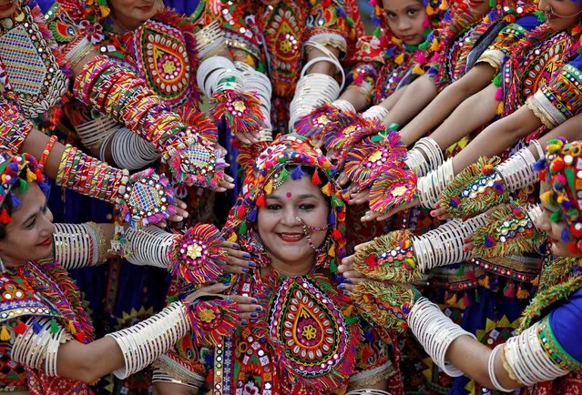 Participants dressed in traditional attire pose for pictures during rehearsals for Garba, a folk dance, in preparations for the upcoming Navratri, a festival during which devotees worship the Hindu goddess Durga, in Ahmedabad, India, September 25, 2019. (Photo by Amit Dave/Reuters)