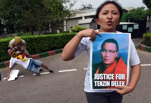 Exiled Tibetan protesters shout slogans against China during a protest outside the Chinese embassy in New Delhi on July 17, 2015. Tibetans were protesting over the untimely death of Tenzin Delek Rinpoche, a prominent Tibetan spiritual teacher in a Chinese prison. (Photo by Prakash Singh/AFP Photo)