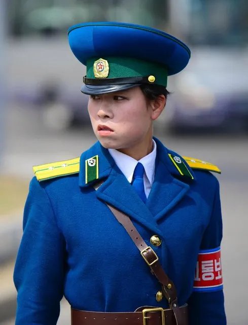 A stoic Pyongyang traffic warden directs traffic in the capital. The predominantly female officers are seen on most intersections in the capital. (Photo by Gavin John/Mediadrumworld.com)