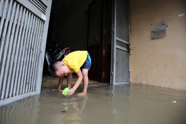 A little boy plays in a flooded alley in Hanoi, Vietnam, 25 May 2016. (Photo by Luong Thai Linh/EPA)